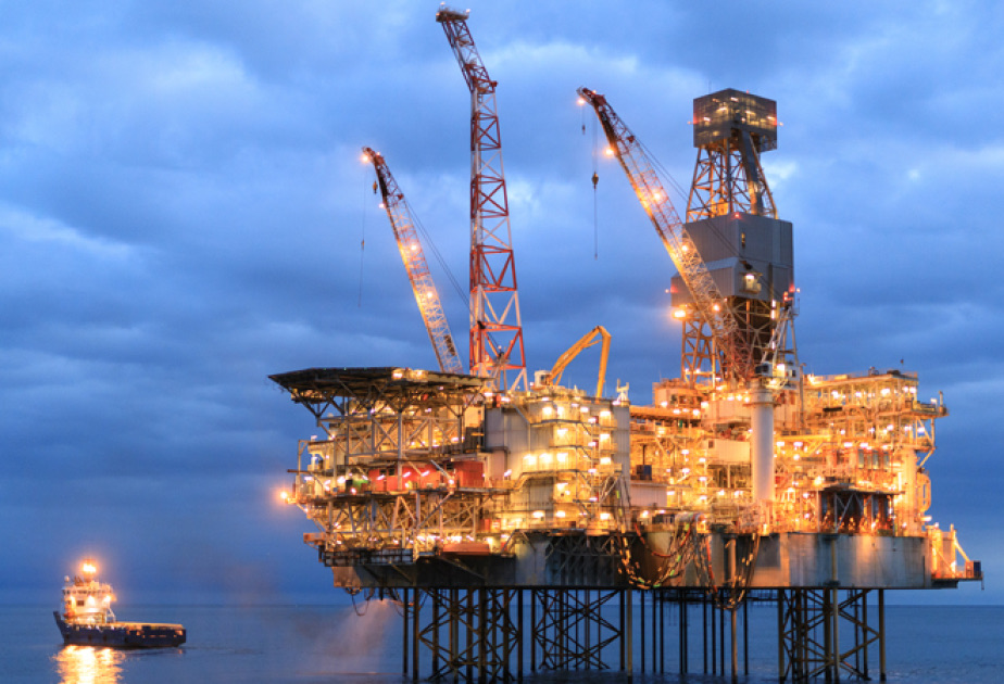 Offshore oil and gas platform in the Caspian Sea at dusk